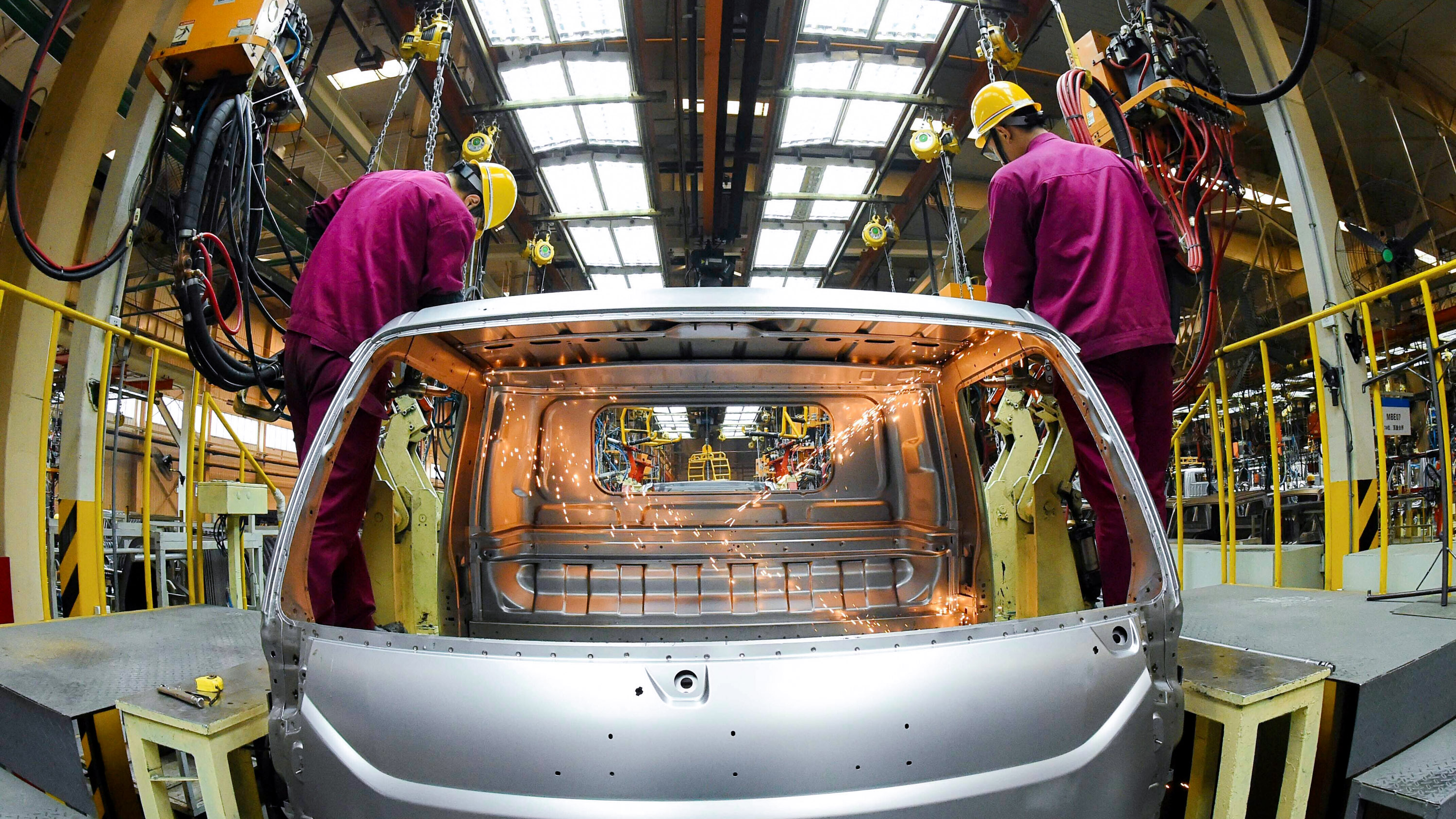 Workers on the assembly line of JAC Motors (Anhui Jianghuai Automobile Co., Ltd.) in Weifang