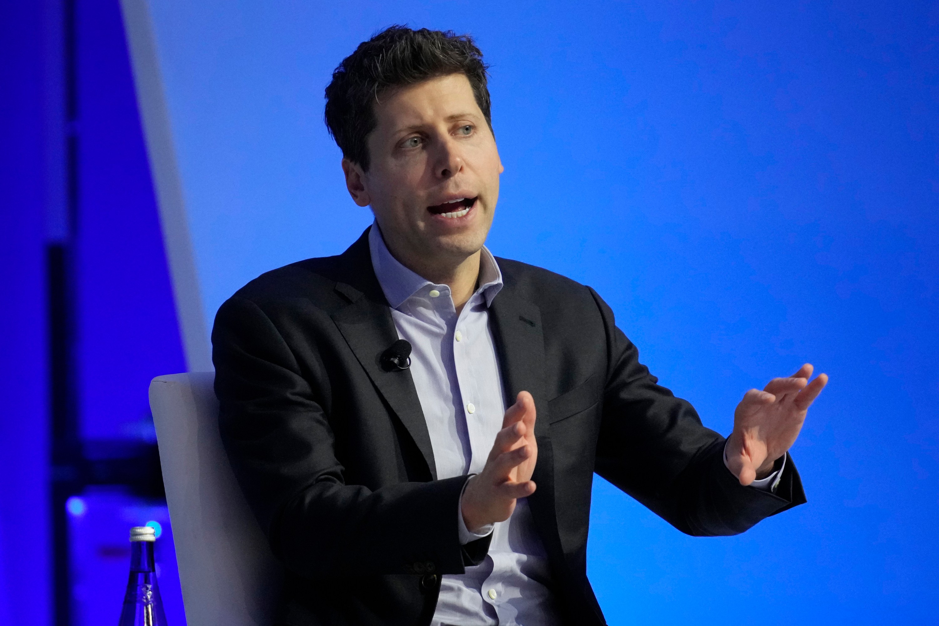 Sam Altman on stage at a conference